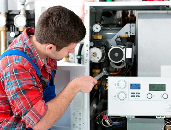 Skilled HVAC technician installing a new furnace unit in Millington, TN with attention to energy efficiency and reliability.