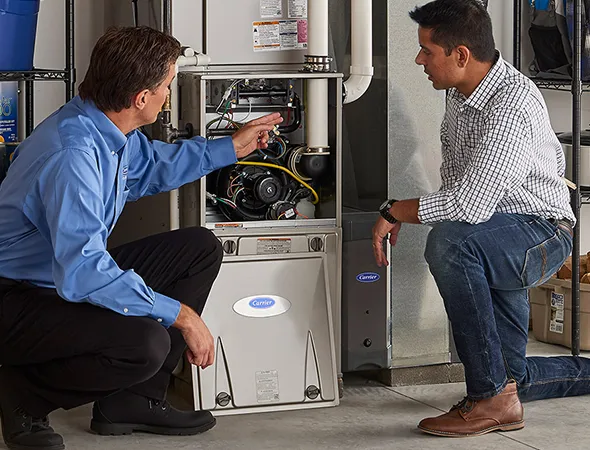 Technician replacing an old furnace with an energy-efficient model in a Lakeland, TN home.